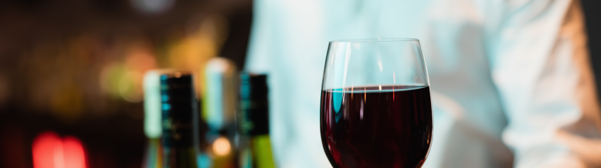bartender-holding-glass-red-wine
